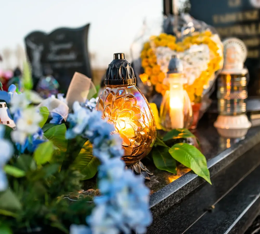 artificial-and-real-flowers-and-lit-candles-lying-2025-03-12-22-08-11-utc